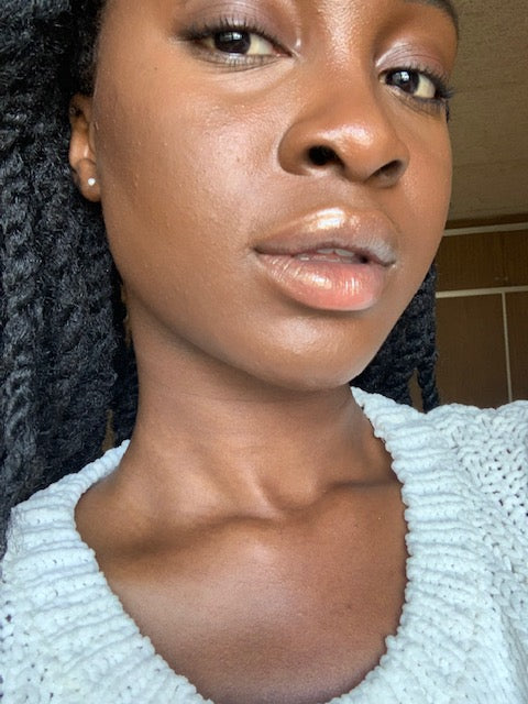 Patience: Dark brown skin with golden undertones. Wearing Afia Gloss