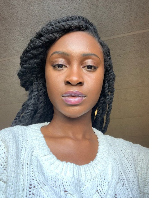 Patience: Dark brown skin with golden undertones. Wearing Akua Gloss